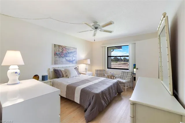 a bedroom with two beds and a table