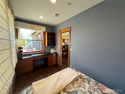 a room with pool table and windows