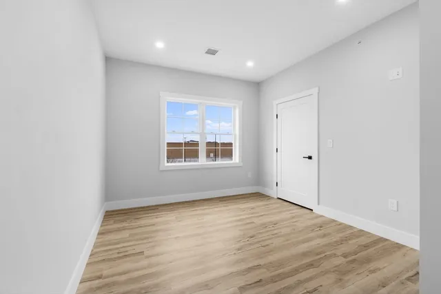 wooden floor in an empty room with a window