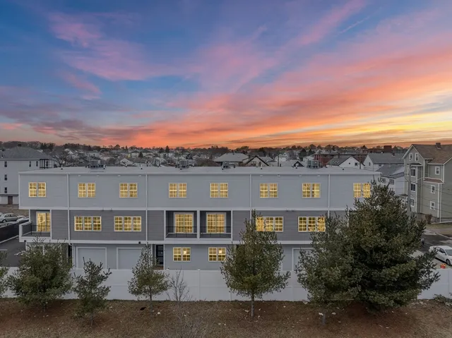 a front view of a multi story residential apartment building with a yard