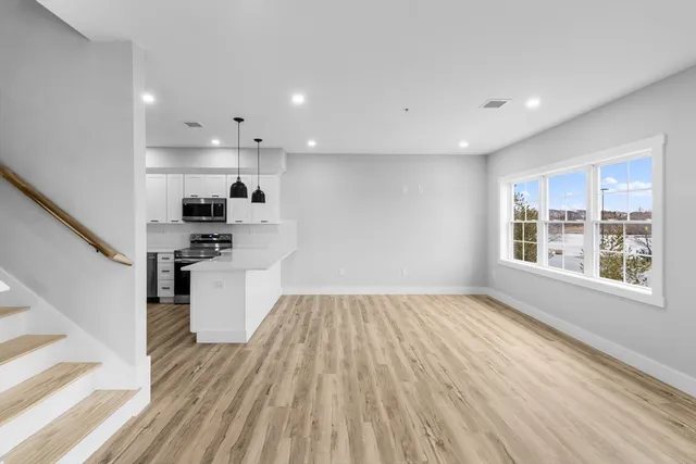 a view of kitchen with sink and wooden floor