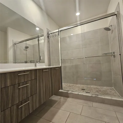 a bathroom with a shower and a sink