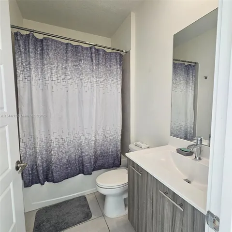 a bathroom with a shower and a toilet