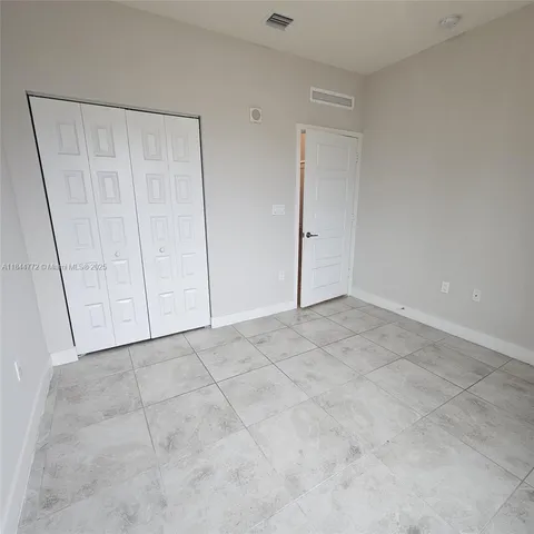 a view of a balcony with wooden floor