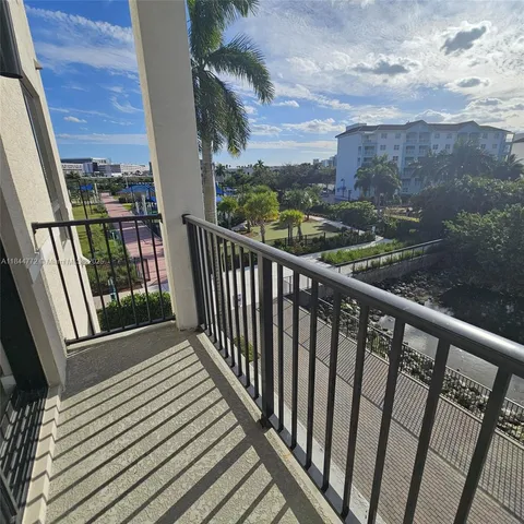 a view of a balcony with wooden floor and lake view