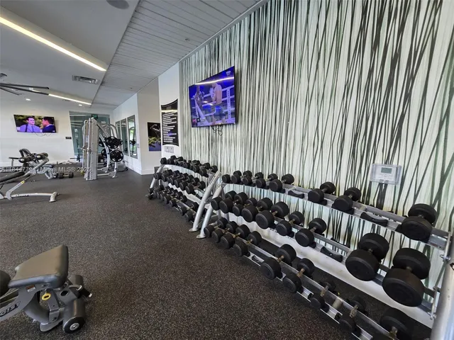 a living room with furniture a large window and a flat screen tv