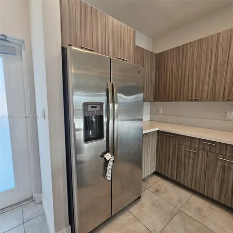 a kitchen with a refrigerator and a sink