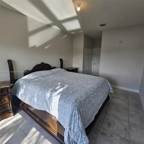 a bedroom with a bed a table and chair