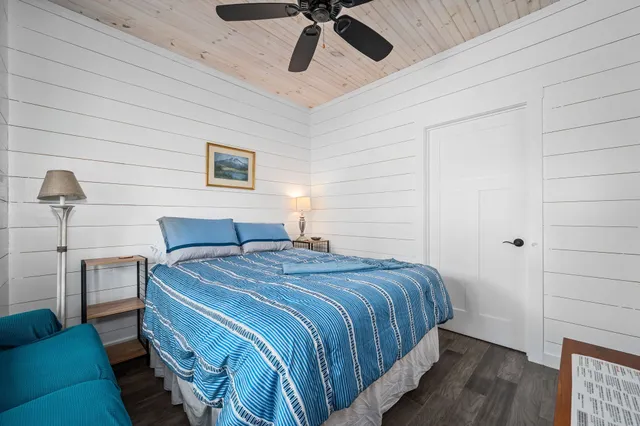 a bedroom with a bed and ceiling fan