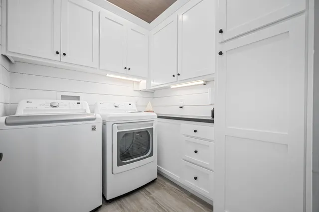 a kitchen with white cabinets and white appliances