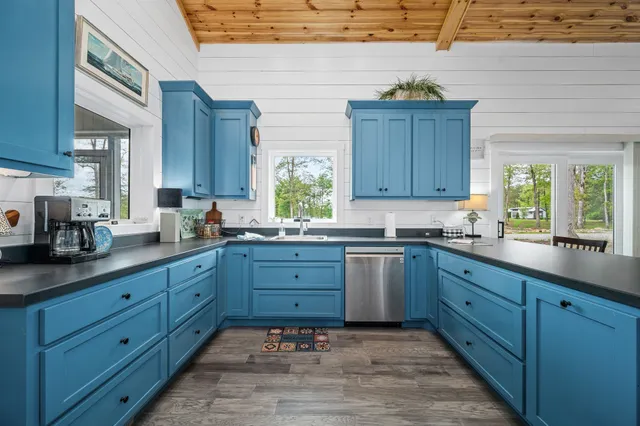 a kitchen with sink and cabinets