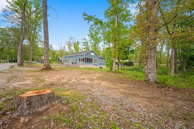 a view of swimming pool with outdoor seating and green space