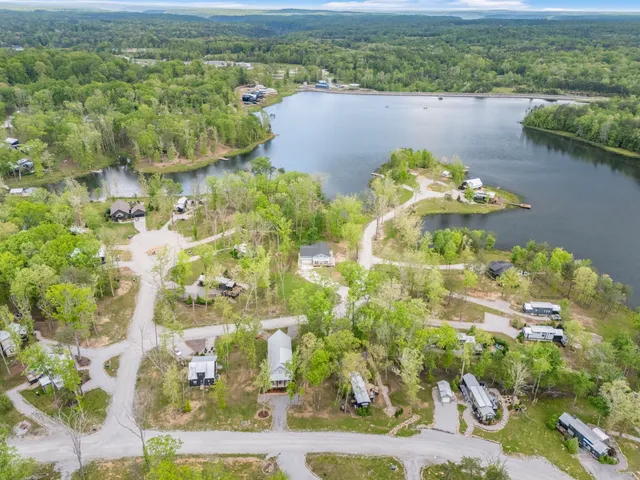 an aerial view of a residential houses with outdoor space