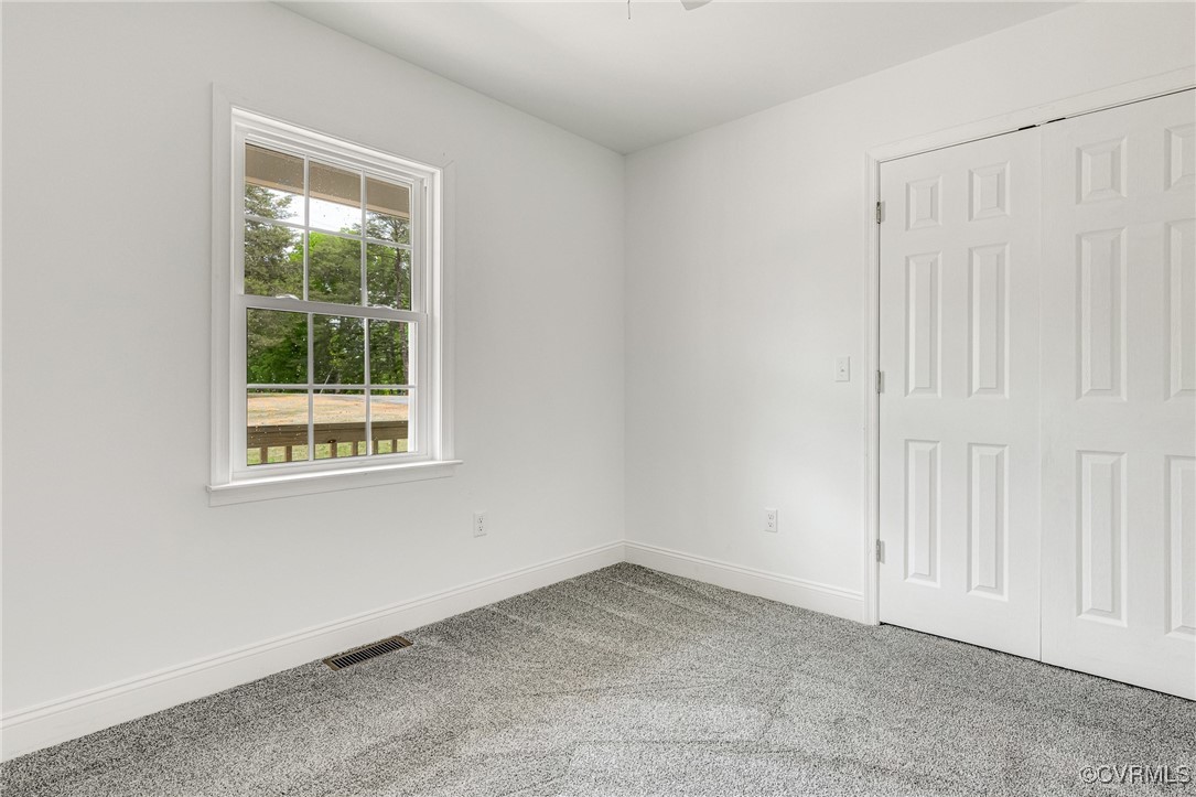 1684 Halls Store Road Mineral, VA 23117 - Photo 23 of 40 Spare room with baseboards, visible vents, and car