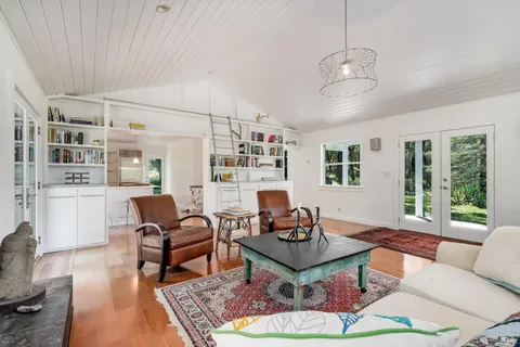 a living room with furniture a rug and a large window