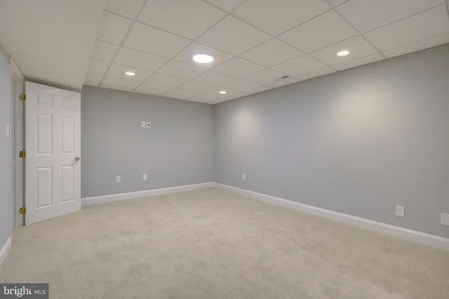 a view of a hallway with wooden floor and stairs