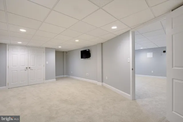a view of a house with a yard covered in snow