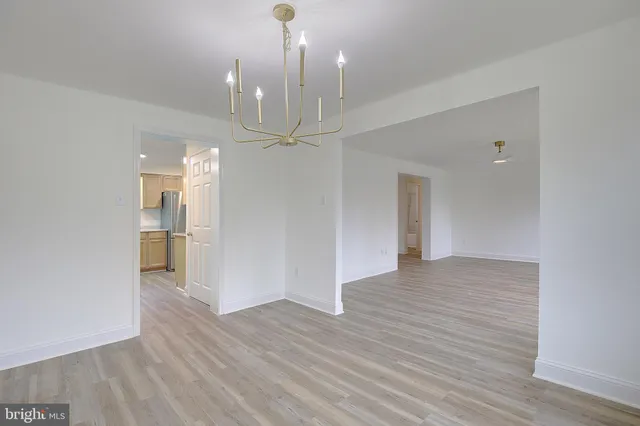 a view of an empty room and wooden floor