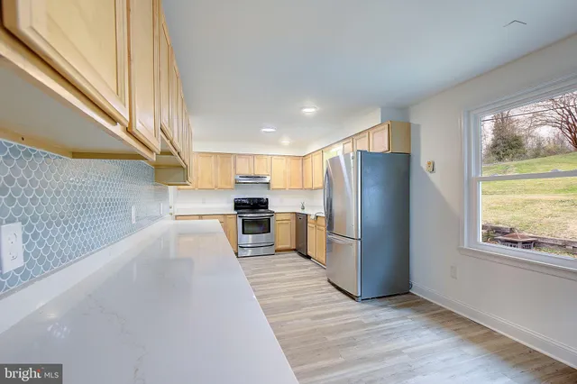 a view of a kitchen with wooden floor and a kitchen