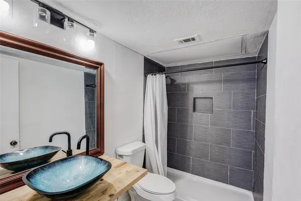 a bathroom with a toilet and a sink