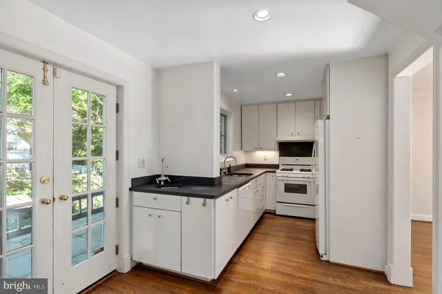 a kitchen with stainless steel appliances a stove a sink and a refrigerator