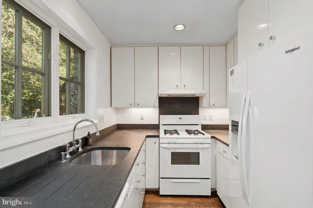 a kitchen with a stove a sink and a microwave