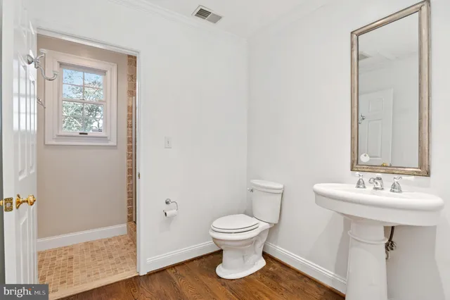 a bathroom with a sink toilet and a mirror