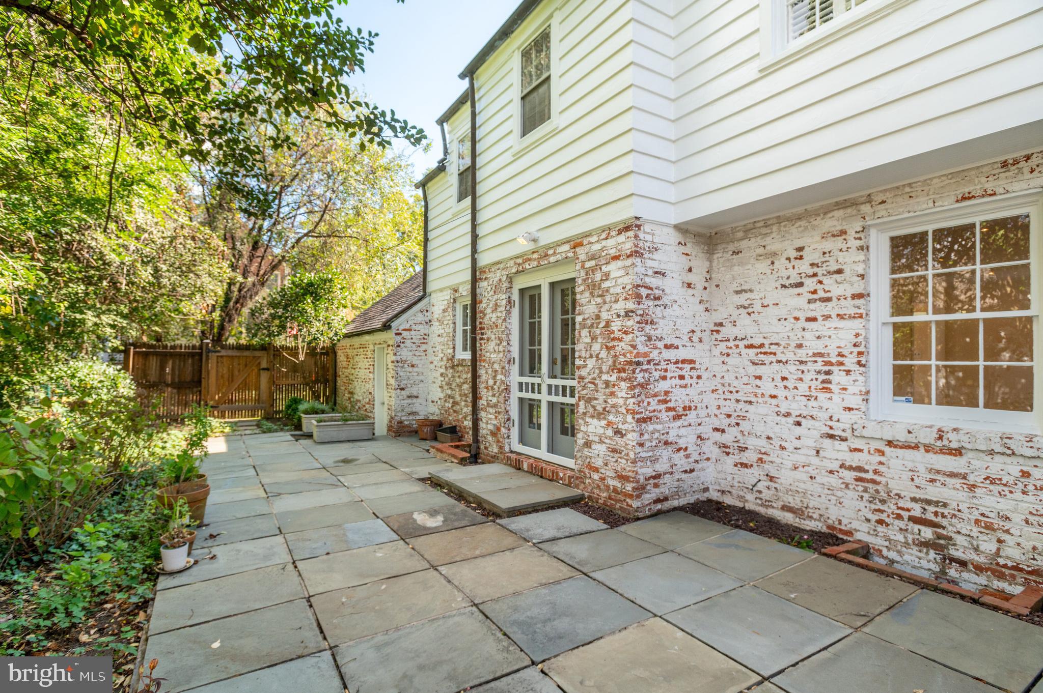4849 Rodman Street Northwest Washington, DC 20016 - Photo 27 of 30 a view of a brick house with a large windows