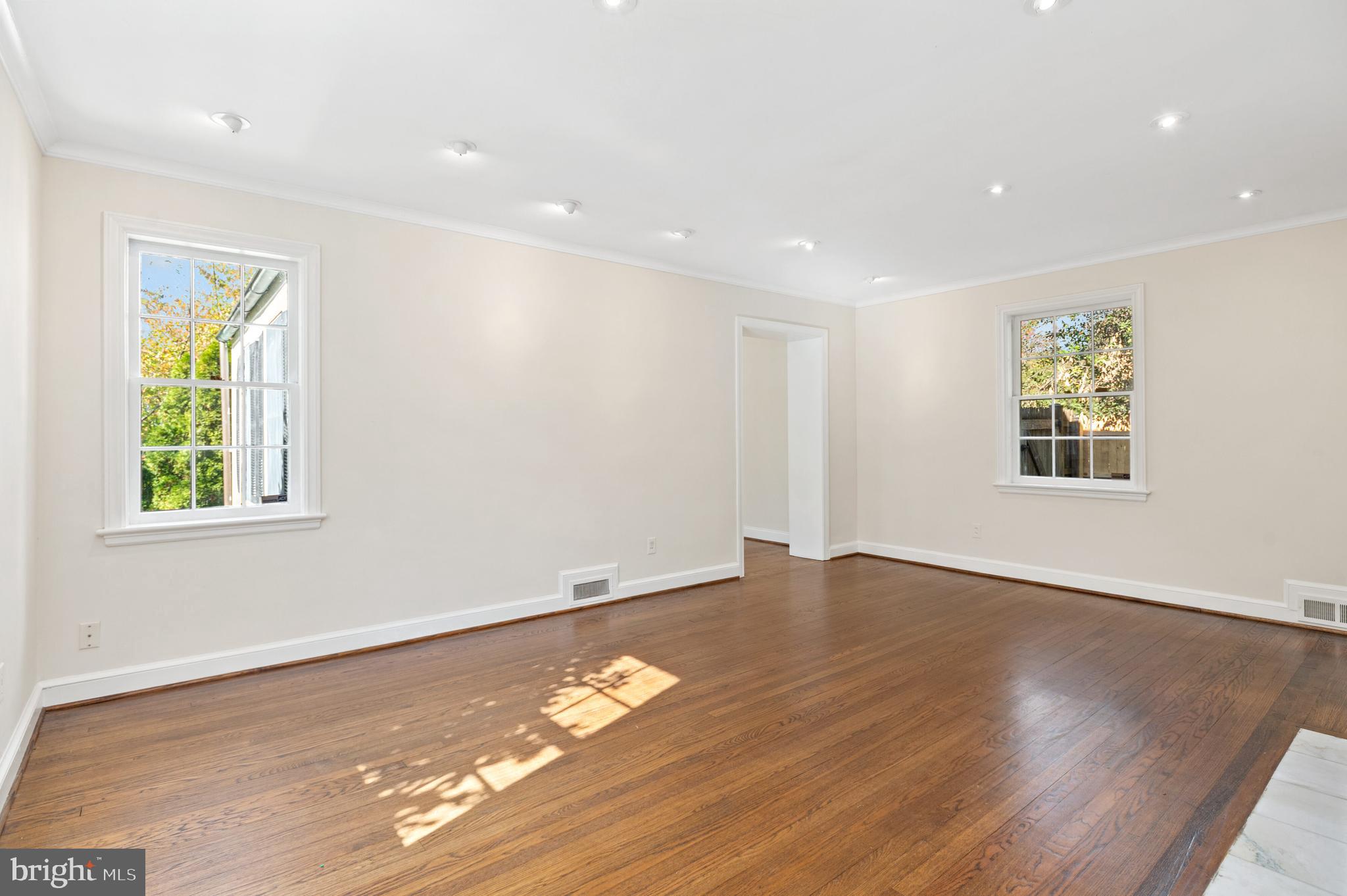4849 Rodman Street Northwest Washington, DC 20016 - Photo 9 of 30 a view of an empty room with wooden floor and a window