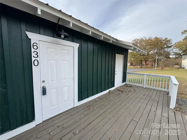 a view of backyard with a wooden deck
