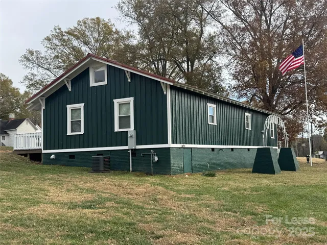 a view of a backyard with a large tree