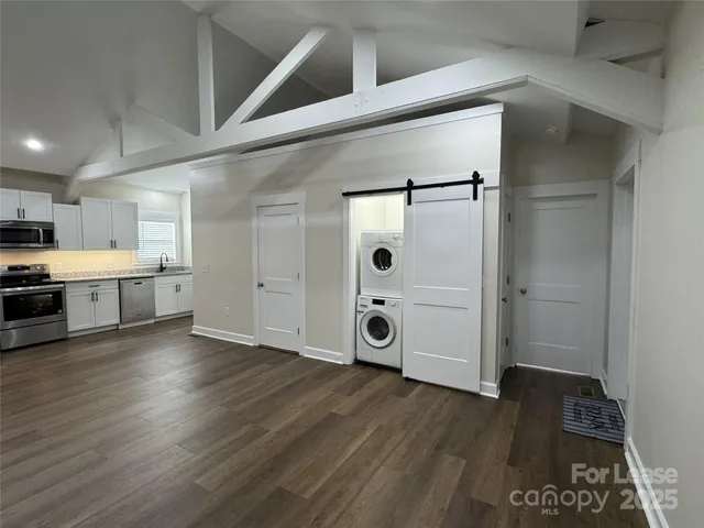 a view of a kitchen with wooden floor and a sink