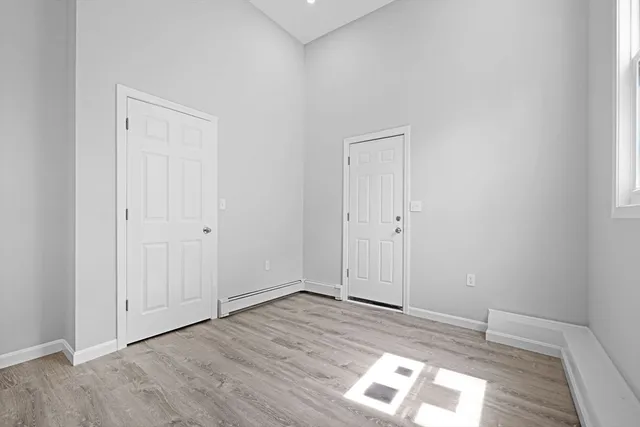 an empty room with wooden floor