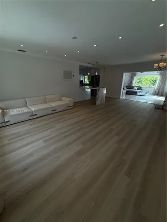 an empty room with wooden floor and outdoor space