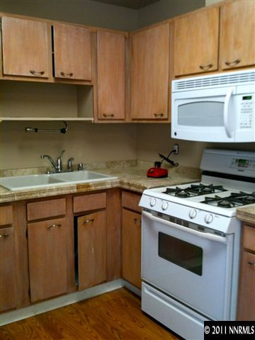 1410 Akard Drive Reno, NV 89503 - Photo 3 of 7 a kitchen with a stove and white cabinets