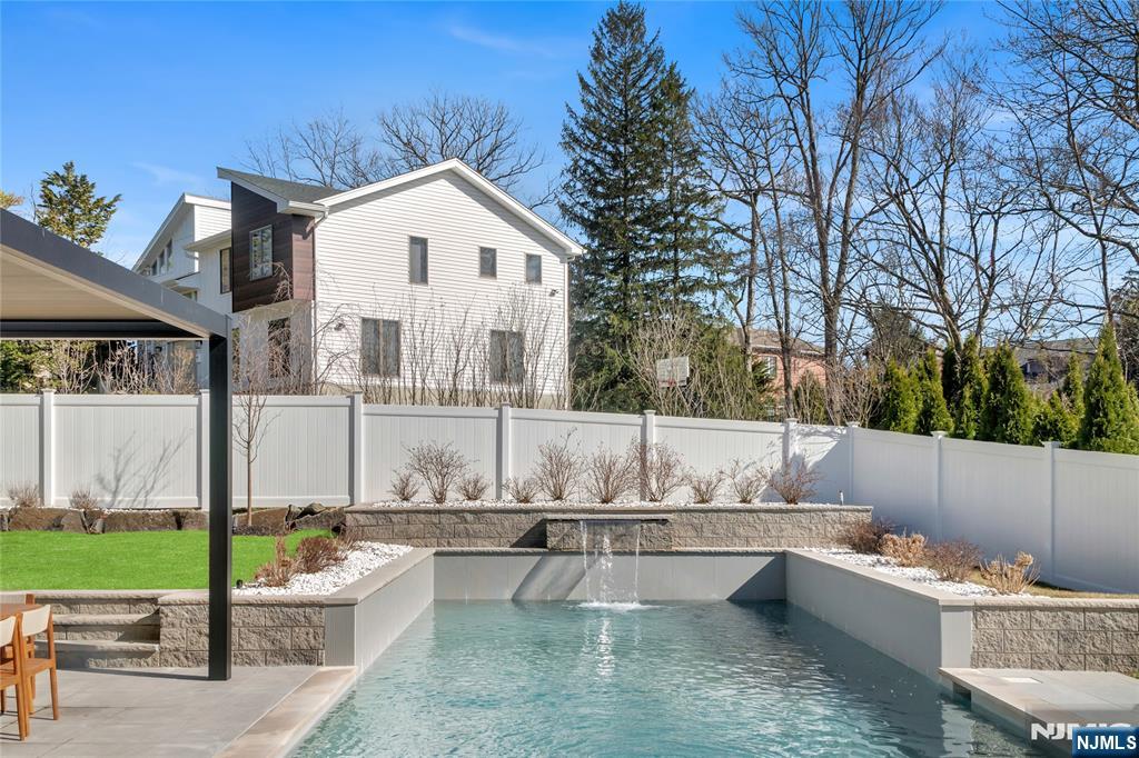 11 Roberts Road Englewood Cliffs, NJ 07632 - Photo 44 of 50 a view of a white house with a yard and sitting area