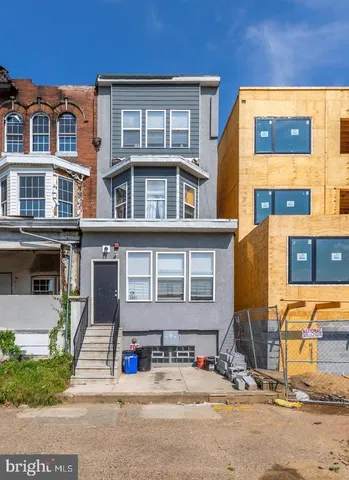 a front view of a residential apartment building with a yard