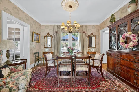 a view of a dining room with furniture and a chandelier