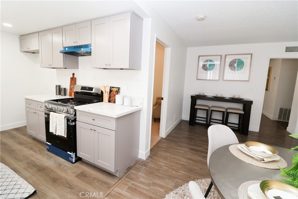 1161 Blue Ridge Lane Colton, CA 92324 - Photo 8 of 36 a kitchen with a stove and a dining table
