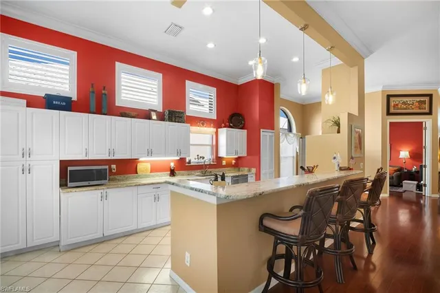 a kitchen with stainless steel appliances kitchen island granite countertop a sink and cabinets