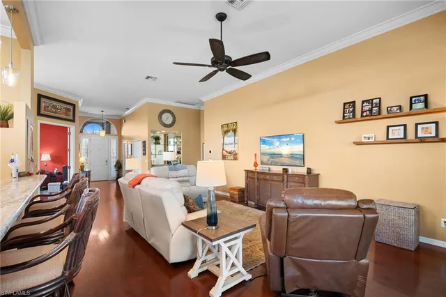 a living room with fireplace furniture and a wooden floor
