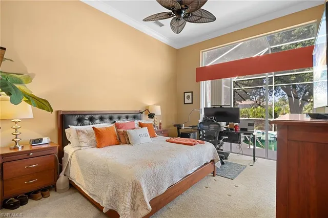 a bedroom with a bed a chandelier and a window