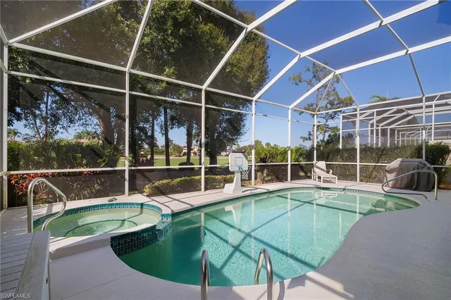 a view of a swimming pool with seating space