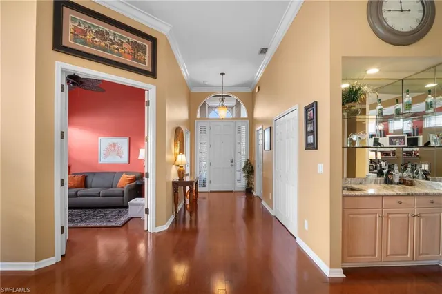 a view of a hallway with livingroom and furniture