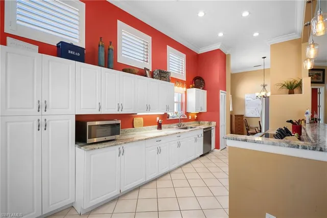a kitchen that has a lot of cabinets in it and appliances