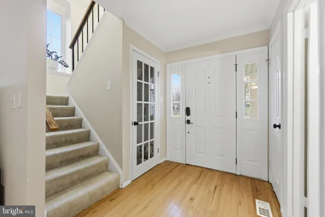 a view of entryway with wooden floor and stairs