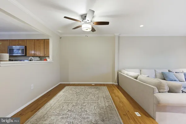 a living room with a couch and chandelier