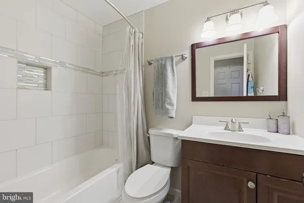 a bathroom with a sink mirror toilet and bathtub