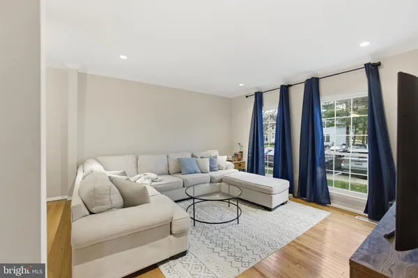 a living room with furniture and large window
