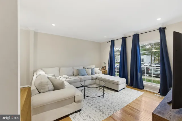 a living room with furniture and large window